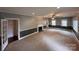 Spacious living room featuring neutral carpet, fireplace, and ample natural light at 131 Glendale Se Ave, Concord, NC 28025