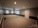 Large living room with neutral carpet, featuring a fireplace and natural light from multiple windows at 131 Glendale Se Ave, Concord, NC 28025