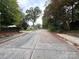 Street view of the neighborhood with mature trees and sidewalks at 131 Glendale Se Ave, Concord, NC 28025