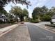 Street view of the neighborhood with mature trees, sidewalks, and landscaping at 131 Glendale Se Ave, Concord, NC 28025
