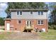 View of brick home with deck, stairs and large windows, set in a grassy yard at 3111 Sandy Porter Rd, Charlotte, NC 28273