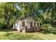 White house with boarded windows, needs renovation. Brick foundation, front porch at 3444 Marvin Rd, Charlotte, NC 28211