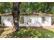Rear view of a white house needing renovation, showing brick foundation at 3444 Marvin Rd, Charlotte, NC 28211