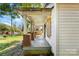 Rustic front porch with brick columns and wooden flooring at 3444 Marvin Rd, Charlotte, NC 28211