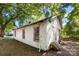White house exterior, needs renovation, side yard view at 3444 Marvin Rd, Charlotte, NC 28211