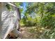 White house exterior, needs work, side yard view with trees at 3444 Marvin Rd, Charlotte, NC 28211