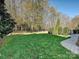 Landscaped backyard with lush green grass and trees at 3481 Fieldstone Dr, Gastonia, NC 28056