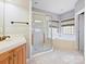 Elegant bathroom featuring a soaking tub, shower, and updated vanity at 3481 Fieldstone Dr, Gastonia, NC 28056