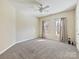 Simple bedroom with neutral walls, ceiling fan, and two windows at 3481 Fieldstone Dr, Gastonia, NC 28056