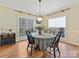 Spacious dining room with hardwood floors, large windows, and a table set for four at 3481 Fieldstone Dr, Gastonia, NC 28056