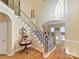 Two-story entryway with hardwood floors and a grand staircase at 3481 Fieldstone Dr, Gastonia, NC 28056