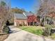 Brick home with a long driveway and lush landscaping at 3481 Fieldstone Dr, Gastonia, NC 28056
