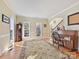 Living room featuring hardwood floors, large windows, and area rug at 3481 Fieldstone Dr, Gastonia, NC 28056