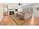 Cozy living room with hardwood floors, fireplace, large sectional sofa, and abundant natural light at 3481 Fieldstone Dr, Gastonia, NC 28056