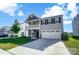 Two-story home with gray siding, stone accents, and a two-car garage at 4423 Falls Lake Sw Dr, Concord, NC 28025