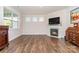 Bright living room features hardwood floors, fireplace, and large windows at 5043 Antebellum Dr, Iron Station, NC 28080