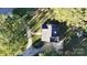 Aerial view showing the home's layout, roof, driveway and surrounding trees at 1000 Hunting Ave, Lincolnton, NC 28092