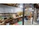 Unfinished basement area with exposed ceiling, concrete walls, and wooden shelving at 1000 Hunting Ave, Lincolnton, NC 28092