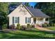 Lovely home with neat landscaping and an inviting front porch with black shutters and trim at 1000 Hunting Ave, Lincolnton, NC 28092