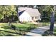 Front exterior view of a home with fenced front yard, mature landscaping, and a paved driveway at 1000 Hunting Ave, Lincolnton, NC 28092