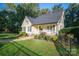 Charming home with a lush front yard, complemented by a picket fence and mature trees at 1000 Hunting Ave, Lincolnton, NC 28092