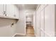 Hallway features wood-look floors, white paint, and several storage closets at 1000 Hunting Ave, Lincolnton, NC 28092