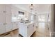 Bright kitchen with white cabinetry, island cooktop, and modern pendant lighting at 1000 Hunting Ave, Lincolnton, NC 28092