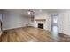 Spacious living room featuring a fireplace, built-in shelves, and hardwood floors at 1000 Hunting Ave, Lincolnton, NC 28092