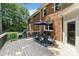 Outdoor deck with dining area and grill perfect for backyard entertaining, off of brick home at 1134 Willow Oaks Trl, Matthews, NC 28104