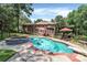 Gorgeous backyard with a large swimming pool, hot tub, and lush landscaping, off brick home at 1134 Willow Oaks Trl, Matthews, NC 28104