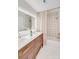 Well-lit bathroom with modern double vanity, patterned shower tile, and gold hardware at 1134 Willow Oaks Trl, Matthews, NC 28104