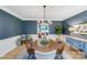 Formal dining room featuring an elegant light fixture and hardwood floors at 1134 Willow Oaks Trl, Matthews, NC 28104