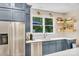 Modern kitchen featuring stainless steel appliances, shaker cabinets, and floating shelves at 1134 Willow Oaks Trl, Matthews, NC 28104