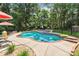 Backyard swimming pool with hot tub and landscaped patio, surrounded by lush greenery at 1134 Willow Oaks Trl, Matthews, NC 28104