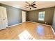 Cozy bedroom with hardwood floors, a ceiling fan, and a large window at 125 Pineville Rd, Statesville, NC 28677