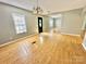 Bright living room with hardwood floors and a chandelier over the entryway at 125 Pineville Rd, Statesville, NC 28677