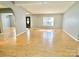 Open-concept living room with hardwood floors, lots of sunlight, and neutral paint at 125 Pineville Rd, Statesville, NC 28677