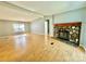 Bright living room featuring hardwood floors and a stone fireplace at 125 Pineville Rd, Statesville, NC 28677