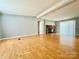 Cozy living room featuring hardwood floors and a stone fireplace at 125 Pineville Rd, Statesville, NC 28677