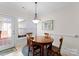 Bright dining area with a wooden table and chairs, offering access to backyard at 155 Harper Lee St, Davidson, NC 28036