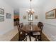 Bright dining room with chandelier and wooden table with six chairs at 155 Harper Lee St, Davidson, NC 28036