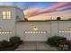 Attached garage with white door and landscaping at 155 Harper Lee St, Davidson, NC 28036