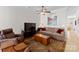 Cozy Gathering room with brown leather chairs, TV, and wooden coffee table at 155 Harper Lee St, Davidson, NC 28036