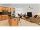 Island kitchen open to living area with granite and stainless steel appliances at 155 Harper Lee St, Davidson, NC 28036