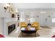 Elegant living room with fireplace, yellow armchairs and coffee table at 155 Harper Lee St, Davidson, NC 28036