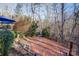 Landscaped backyard with stone path, wooden fence, and mature trees at 7324 Friar Tuck Ln, Mint Hill, NC 28227