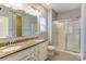 Bathroom with double vanity, granite countertop, and a glass shower at 7324 Friar Tuck Ln, Mint Hill, NC 28227