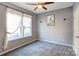 Bright bedroom with gray walls, carpet, and ceiling fan at 7324 Friar Tuck Ln, Mint Hill, NC 28227