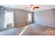 Bright bedroom with gray walls, carpet, and two windows at 7324 Friar Tuck Ln, Mint Hill, NC 28227