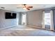 Spacious bedroom with gray walls, carpet, and wall-mounted TV at 7324 Friar Tuck Ln, Mint Hill, NC 28227